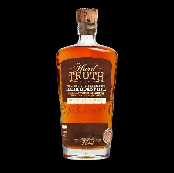 Bottle of Hard Truth Master Distiller's Reserve Dark Roast Rye Bottled in Bond with a dark brown label, gold accents and cork top