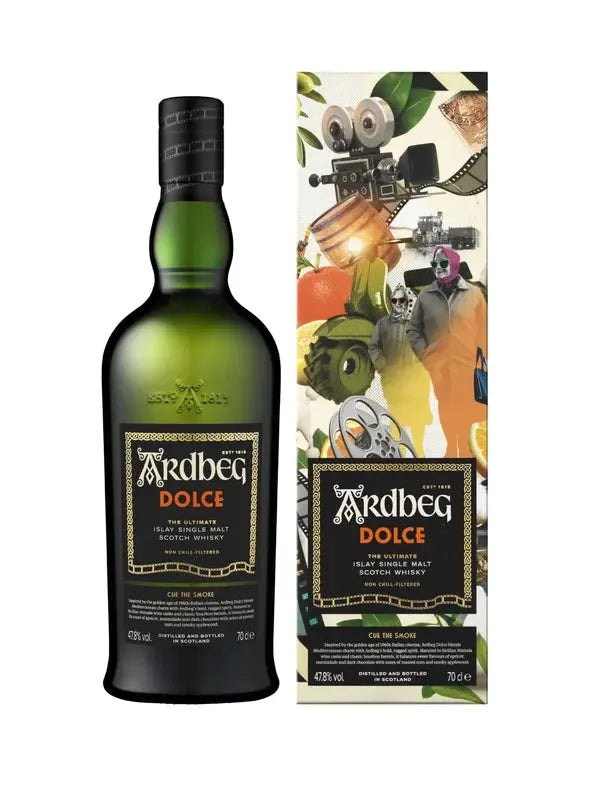 A green bottle of Ardbeg Dolce “Cue the Smoke” Islay Single Malt Scotch Whisky 750mL stands beside its colorful box, decorated with playful, surreal illustrations of a robot, fruit, gears, and faces.