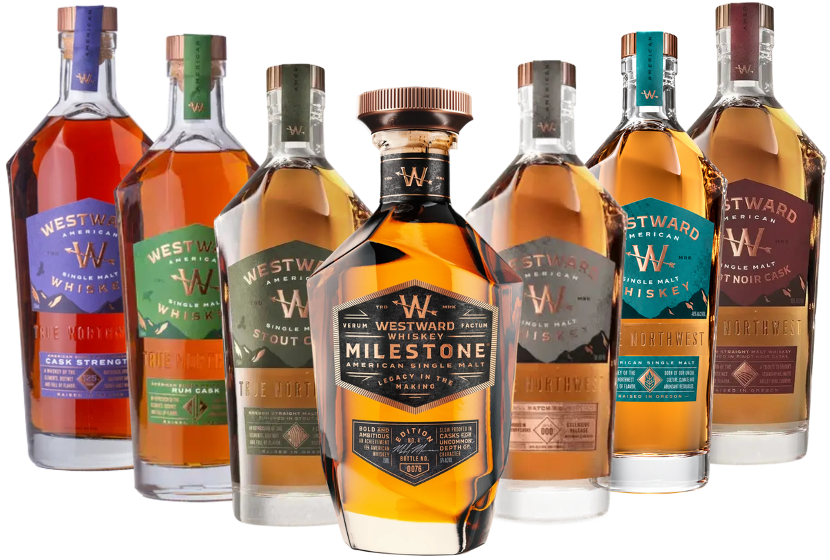 Seven bottles of Westward Whiskey, each featuring a unique and vibrant label and including the Milestone Edition No. 4, Cask Strength, Rum Cask, Stout Cask, PX Sherry Cask, Pinot Noir Cask, and Single Malt expressions, are elegantly arranged in a semi-circle; the Milestone Edition No. 4 bottle sits at the center as the highlight of this impressive Westward Whiskey American Legacy 7-Bottle Bundle (Pre-Order).