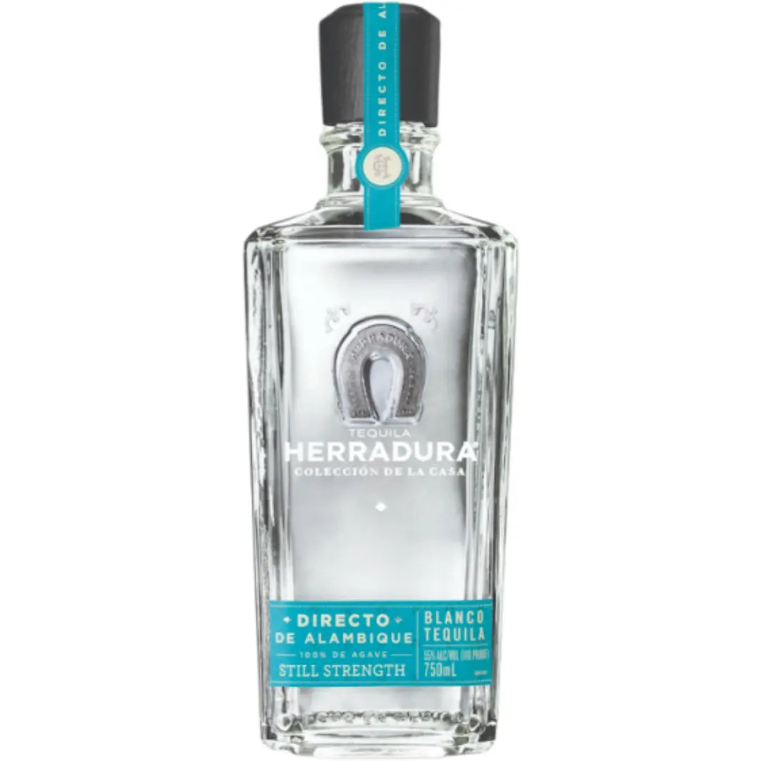 A clear 750ml glass bottle of Herradura Tequila’s 2027 Limited Edition Directo de Alambique Blanco, crafted from 100% Blue Weber agave, features turquoise and silver labels adorned with a horseshoe emblem. This high-proof blanco tequila delivers an authentic expression for discerning enthusiasts.