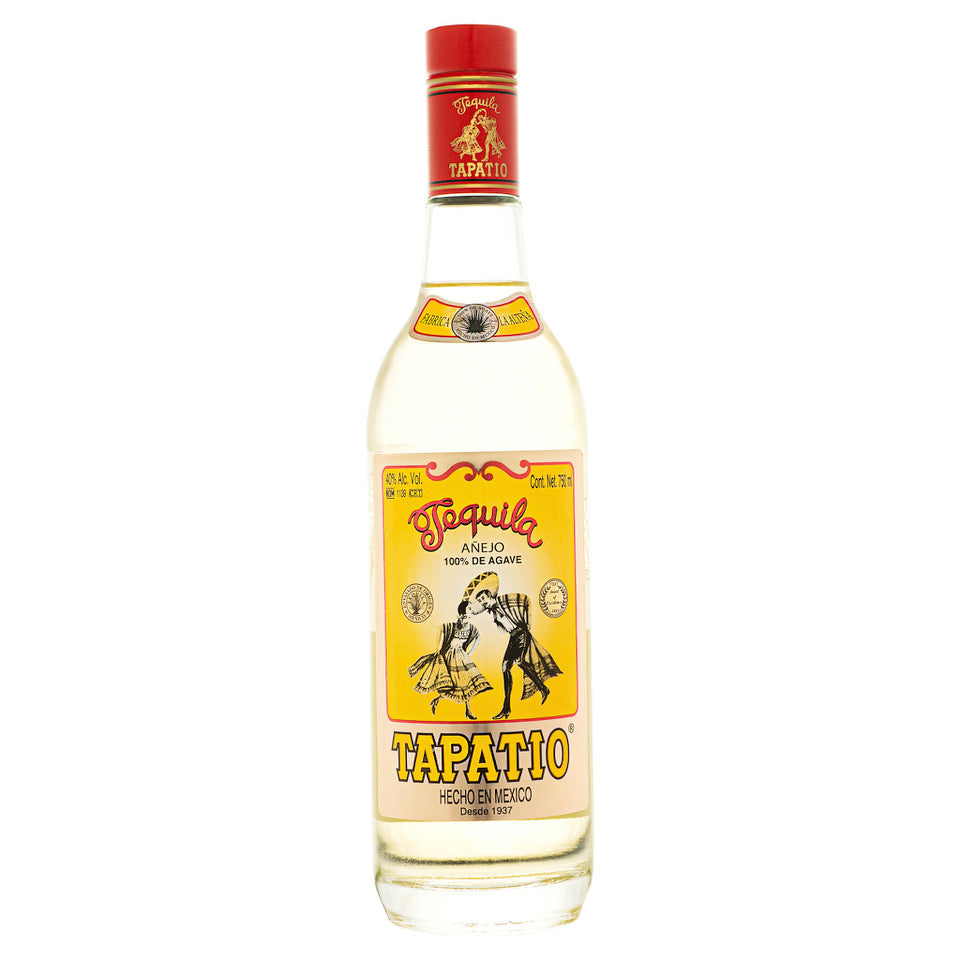 A 750mL bottle of Tapatio Anejo Tequila by Tapatio, made from highland blue agave and aged in bourbon barrels, featuring a yellow label adorned with a man wearing a sombrero and displaying the phrases “Hecho en Mexico” and “100% de agave.”.