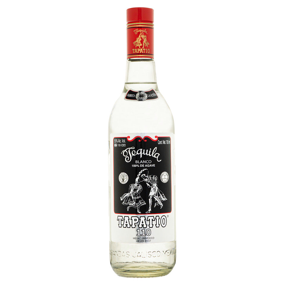 A clear glass bottle of Tapatio High Proof Blanco Tequila, topped with a red cap and adorned with a black and white label featuring two dancers. The label displays “100% de Agave” and “Tapatío 110,” showcasing this highland tequila as an authentic agave spirit. Embodying the bold character of the Tapatio brand, this distinctive bottle of High Proof Blanco Tequila stands out for its authenticity and heritage.