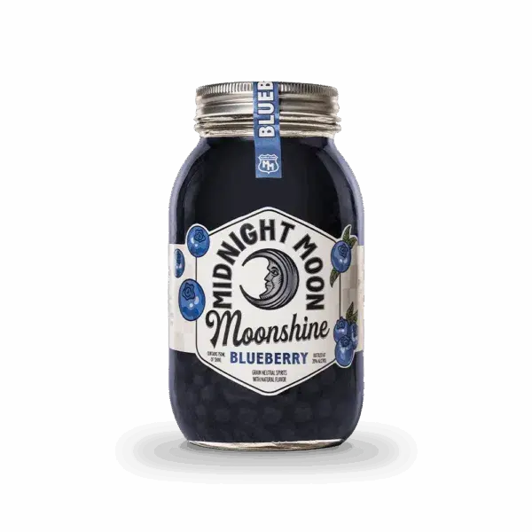 A clear mason jar of Midnight Moon Blueberry Moonshine by Midnight Moon Moonshine has a crescent moon and blueberries on the label, a sealed silver lid, and a small blue tag. The dark blue moonshine is visible inside.