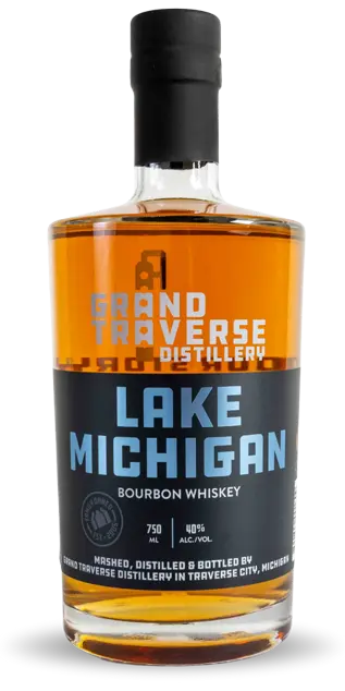 A bottle of Grand Traverse Distillery Lake Michigan Bourbon features amber liquid and a black and blue label with the brand name—a true Michigan bourbon for craft enthusiasts.