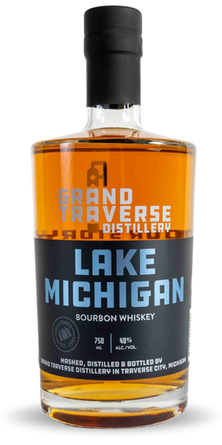A bottle of Grand Traverse Distillery Lake Michigan Bourbon features amber liquid and a black and blue label with the brand name—a true Michigan bourbon for craft enthusiasts.