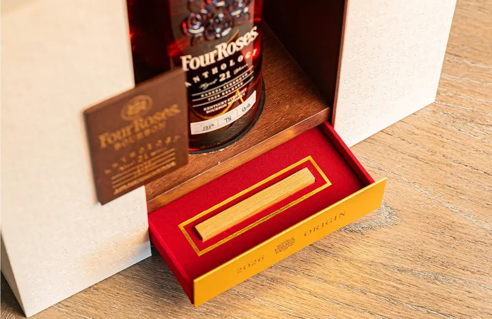Four Roses The Anthology Series Chapter 1: Origin 21 Year Bourbon from Main Street Liquor is presented in an elegant box with a red velvet compartment and gold plaque, set on a wooden surface—an impressive collectible bourbon display.