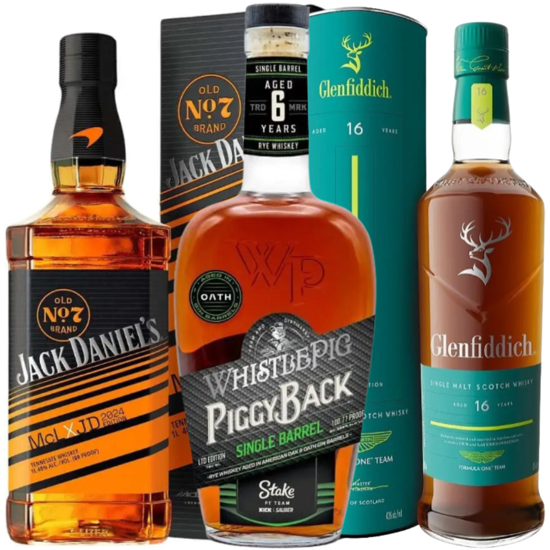 Four whiskey bottles and boxes, including the Formula 1 Bundle: Glenfiddich Aston Martin, Jack Daniel’s x McLaren, and WhistlePig Stake x Kick Sauber by Main Street Liquor, are arranged upright together against a white background.