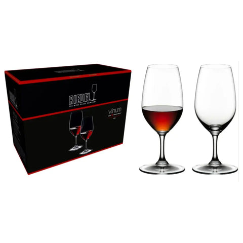 A box labeled "RIEDEL Wine Glass Vinum Port Set of 2" by Riedel is placed next to two elegant crystal stemware glasses—one filled with red wine and the other empty—set against a pristine white background.