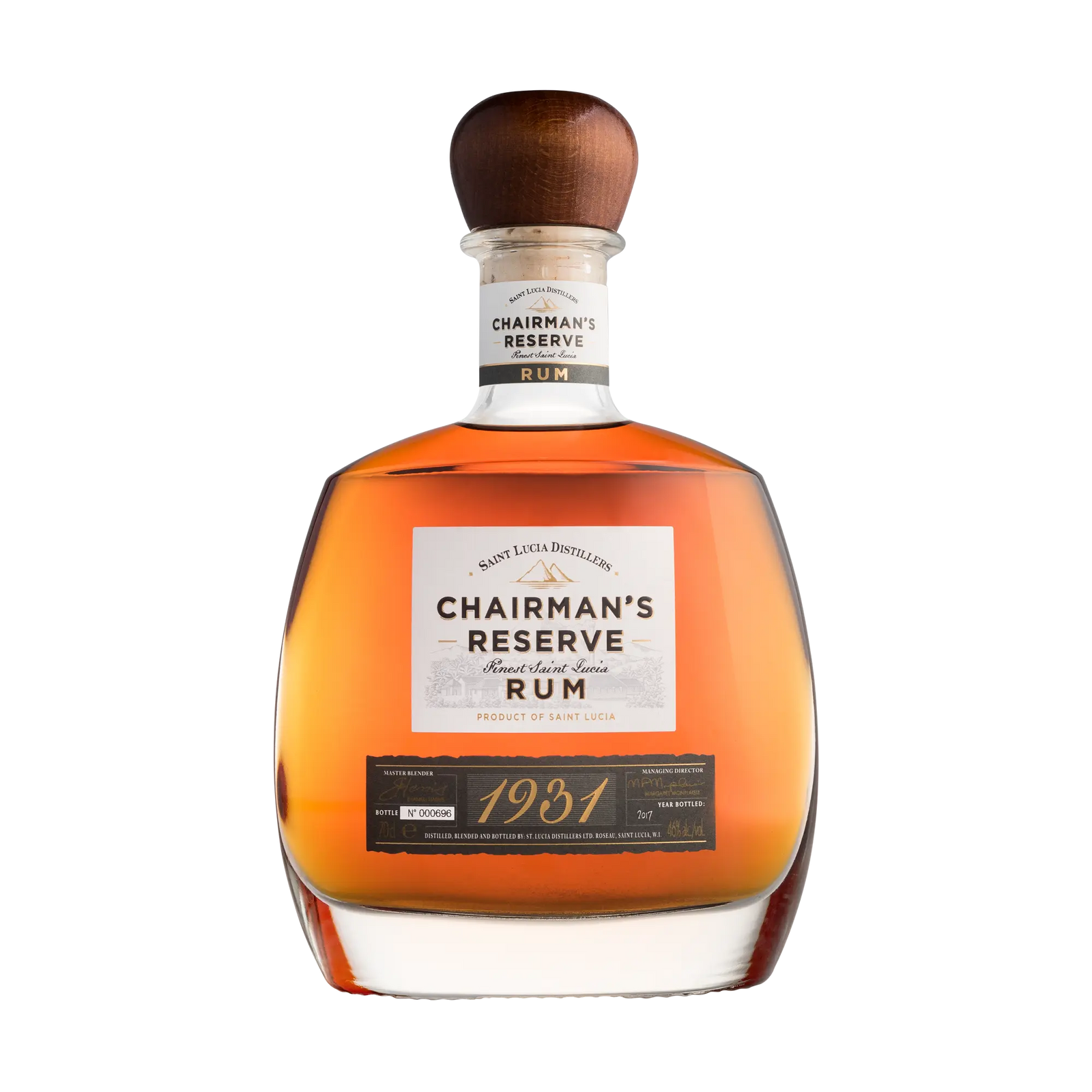 A bottle of Chairman's Reserve 1931 Rum features a wooden cap, amber liquid inside, and a white label with the Chairman's Reserve Rum brand and product details.