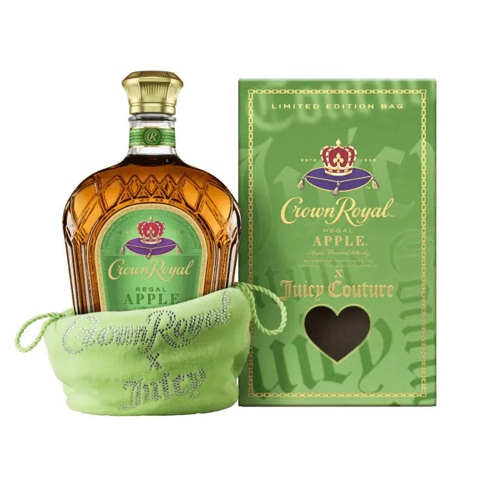 A bottle of Crown Royal Regal Apple x Juicy Couture Limited Edition is in a light green Juicy Couture bag, next to a matching green gift box with a heart-shaped window.