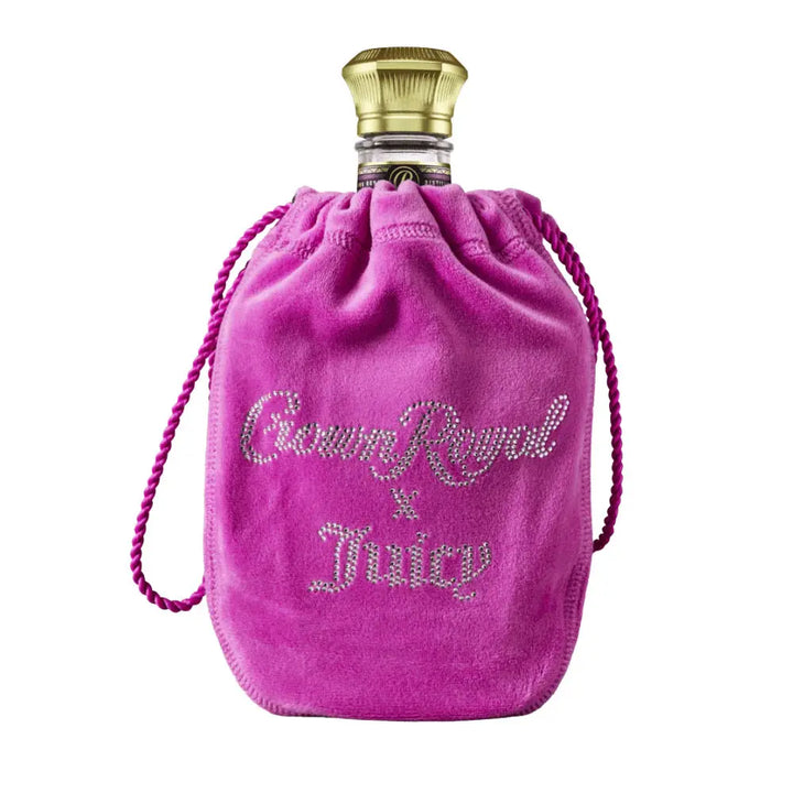 A Crown Royal Blackberry x Juicy Couture Limited Edition bottle in a bright pink velvet bag with “Crown Royal x Juicy” in rhinestone-style letters, marking the exclusive Crown Royal and Juicy Couture collaboration.