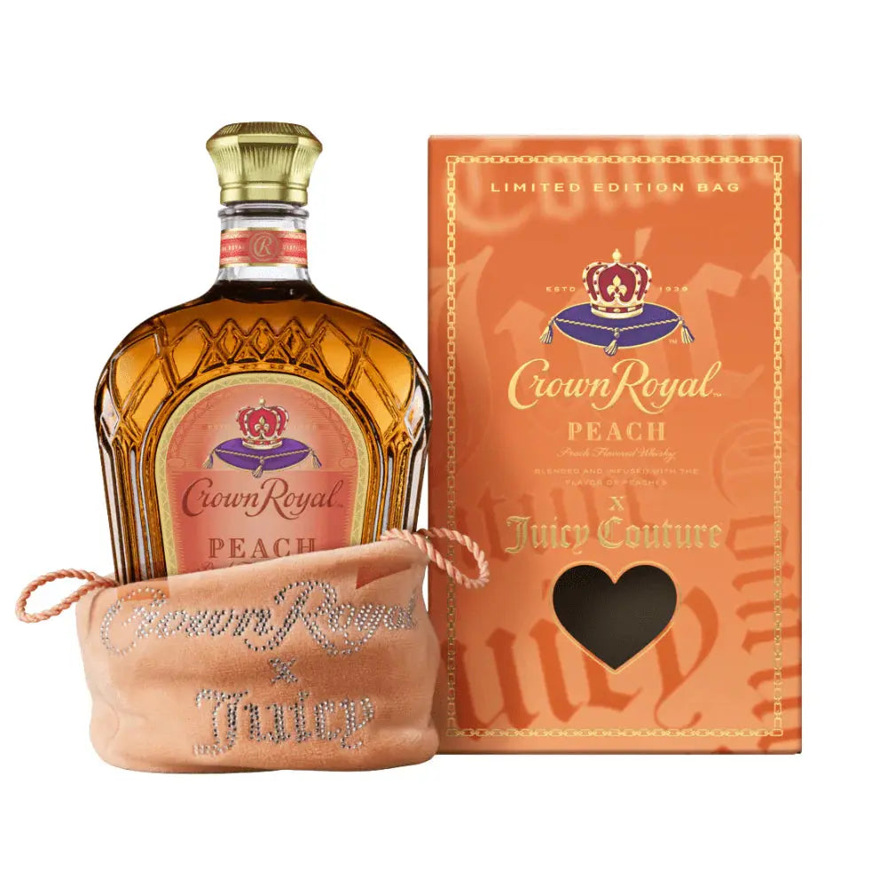 A bottle of Crown Royal Peach X Juicy Couture sits in a jeweled limited-edition Juicy Couture bag next to its matching orange box, which features a heart-shaped window and gold lettering. The packaging displays the Crown Royal brand name.
