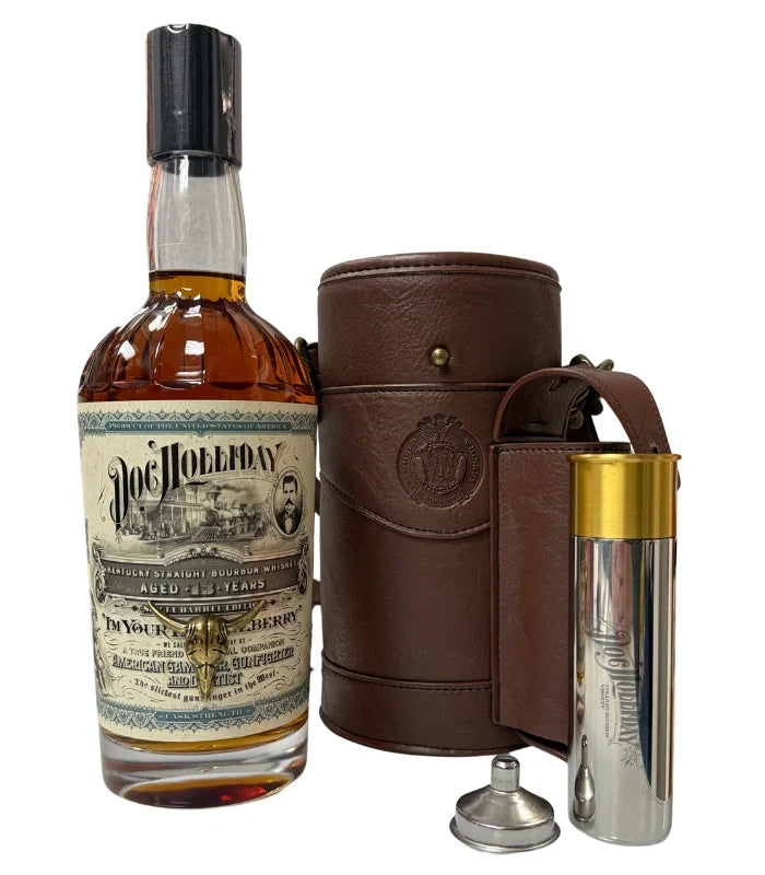 The Doc Holliday 13 Year Single Barrel Bourbon Hunter’s Bag with Shotgun Shell Flask by Doc Holliday is displayed upright with a brown leather case, a gold-capped metal flask, and a small metal funnel against a white background.