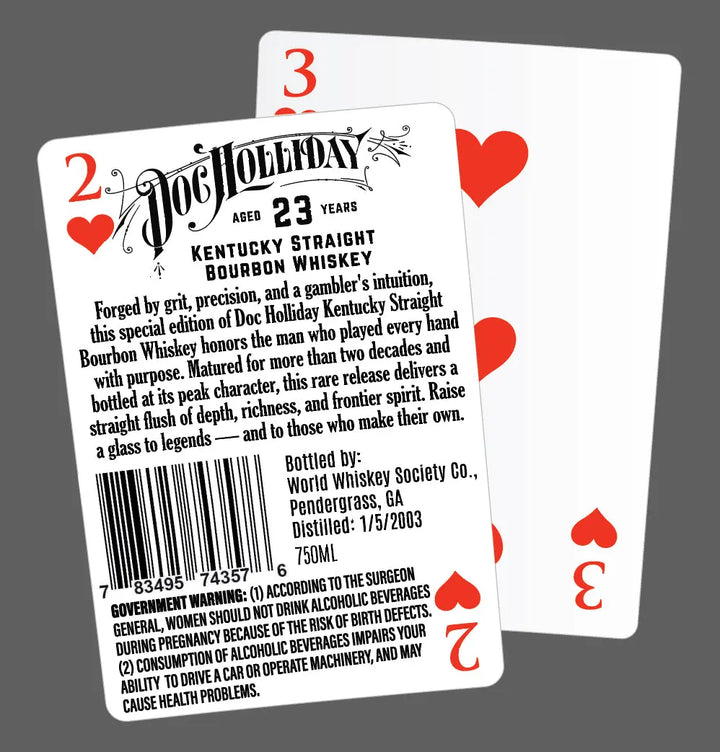 Two playing cards overlap on a gray background. The front card, the 2 of Hearts, displays a label for Doc Holliday 23 Year Kentucky Straight Bourbon Whiskey. The 4 of Hearts card is behind it.