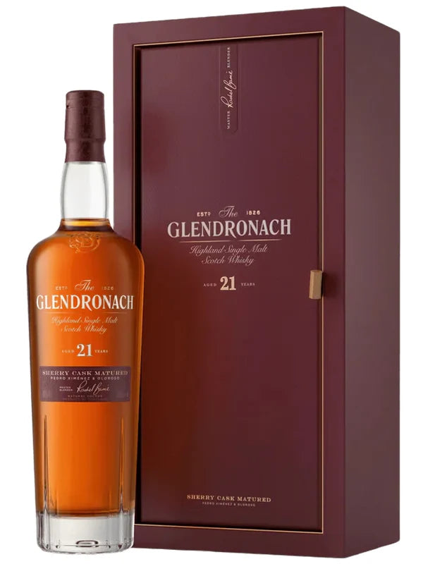 A bottle of The GlenDronach Parliament 21 Years Old single malt Highland Scotch whisky, matured in sherry casks for exceptional depth and richness, stands beside its matching maroon box adorned with gold lettering and a clear window showcasing the bottle.