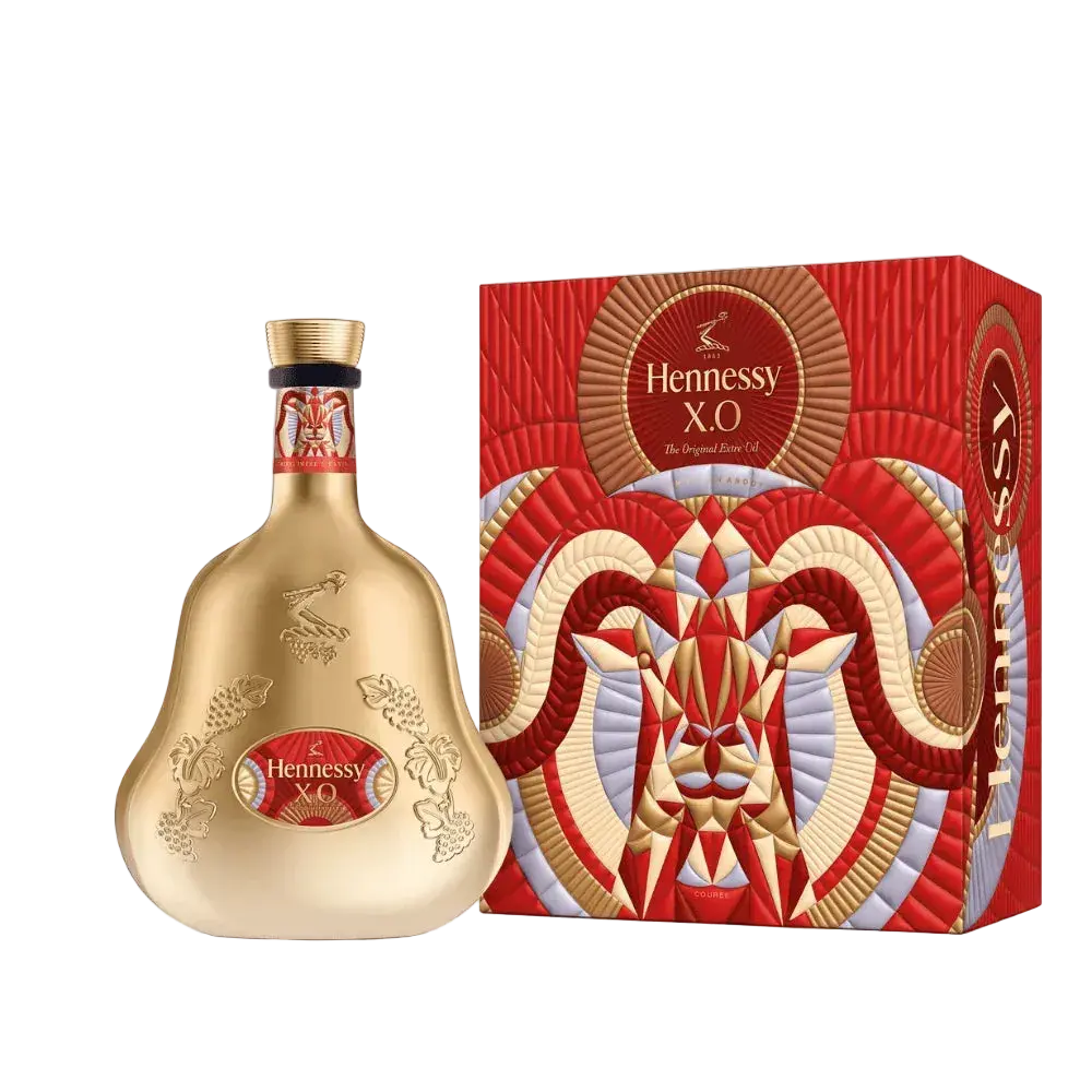 A gold Hennessy X.O Lunar New Year 2027 Year of the Goat decanter and its matching red gift box featuring an abstract goat illustration.