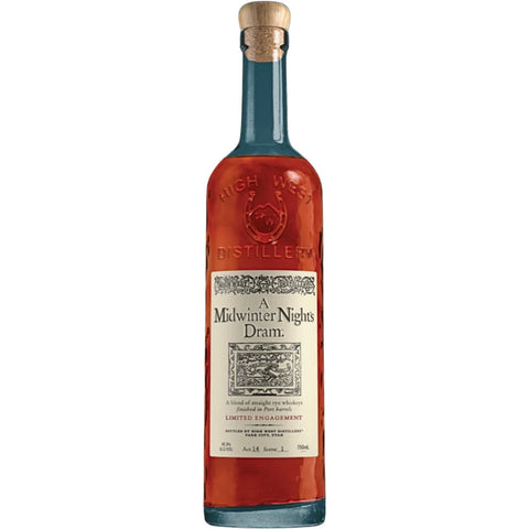 A tall, clear bottle of High West A Midwinter Night’s Dram Act 14 (Pre-Order) whiskey from High West Distillery features a cork top and an ornate cream label. The amber liquid inside is visible, highlighting this limited-release rye whiskey finished in port barrels. “High West Distillery” is embossed on the glass.