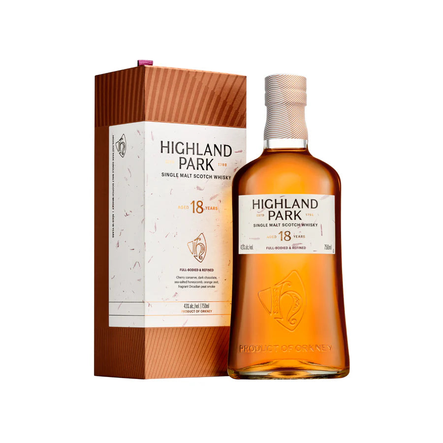 A bottle of Highland Park 18 Year Old stands next to its box, both with white and copper accents and VIKING PRIDE branding. The amber whisky, aged 18 years in sherry-seasoned European oak casks, is highlighted on the packaging.