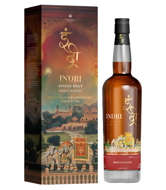 A bottle of Indri Diwali Collector’s Edition 2025 Indian Single Malt Whisky Marsala Cask Finish stands beside its decorative box, featuring colorful artwork of elephants, palaces, and lush Indian scenery.