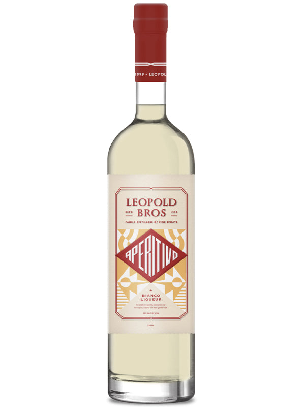 A clear glass bottle of Leopold Bros Aperitivo Bianco floral aperitif, with a red cap and a cream, gold, and red geometric label, stands upright on a white background.