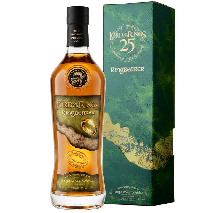 A bottle of Pōkeno The Lord of the Rings 25th Anniversary Ringbearer “The One Ring” Engraving Edition Single Malt Whisky 700mL by Pōkeno Whisky stands next to its green, gold, and blue box, both adorned with Lord of the Rings themed artwork and imagery of the One Ring. This exclusive New Zealand single malt is part of the coveted “The One Ring” Engraving Edition, making it a standout piece for any Lord of the Rings whisky collector.