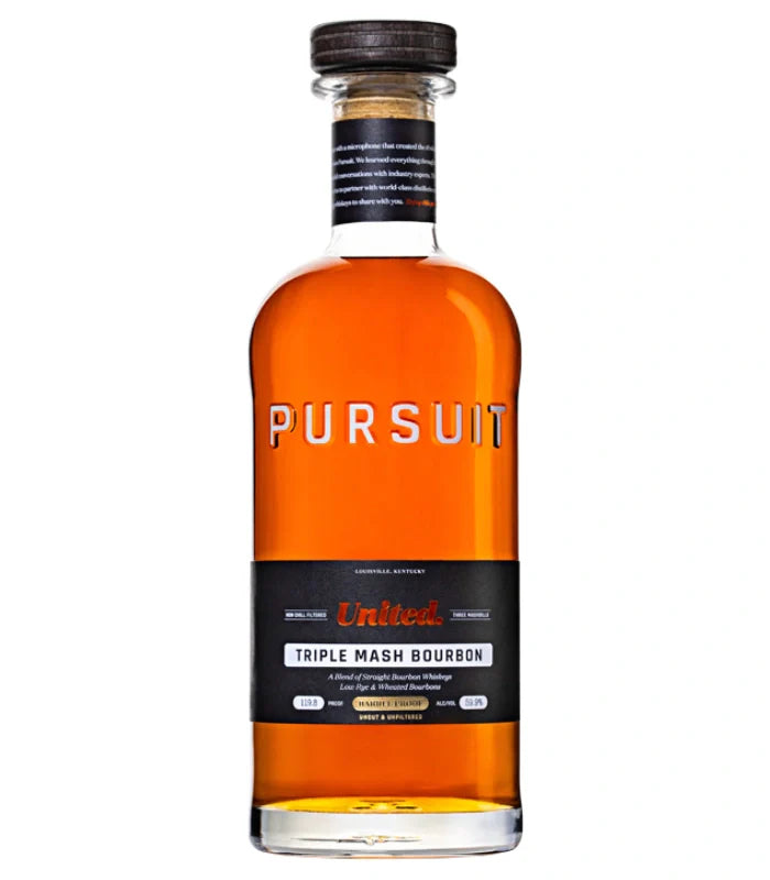 A 700mL bottle of Pursuit United Barrel Proof Triple Mash Bourbon from Pursuit Spirits features amber liquid in clear glass, a wooden cap, and a black label with orange and white brand and product details.