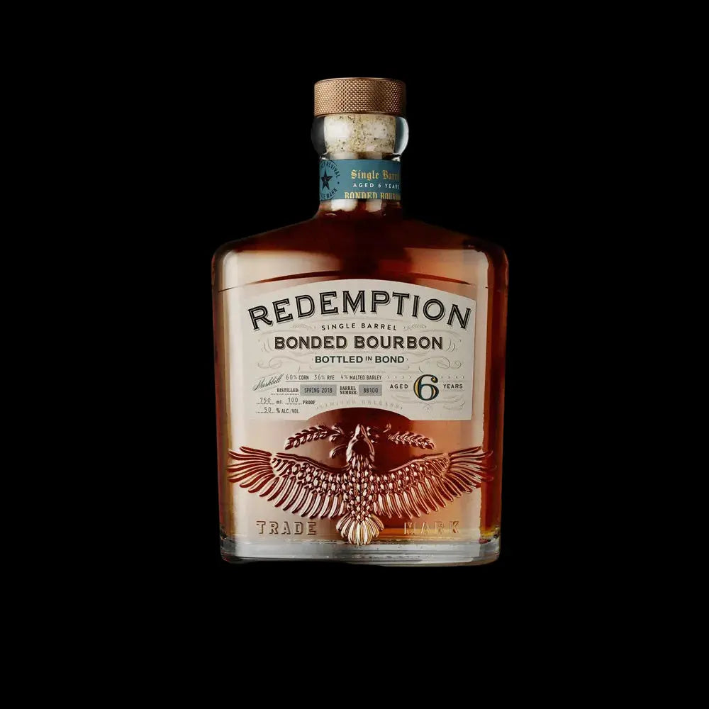 A bottle of Redemption Single Barrel Bottled in Bond Bourbon 6 Year by Redemption, showcasing a decorative eagle design and labeled as a high-rye, 6-year-old Bottled in Bond bourbon, stands out against a striking black background.