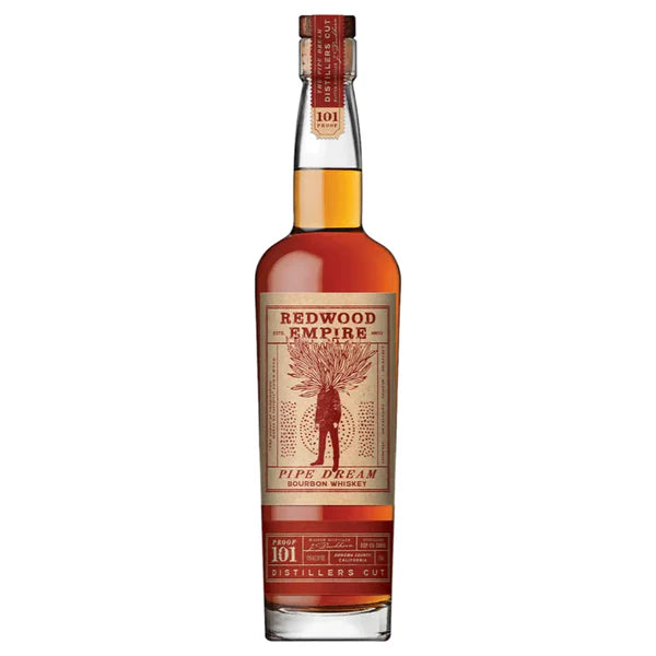 A bottle of Redwood Empire Pipe Dream 101 Bourbon Whiskey by Redwood Empire Whiskey features a tan and red label with a tree illustration, red neck seal, and contains rich amber whiskey from Sonoma County.