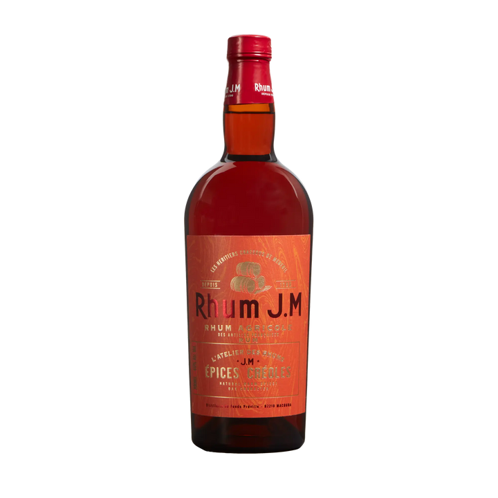 A bottle of Rhum J.M Atelier Épices Créoles features a red label and cap with gold and white text, decorative tropical patterns, and highlights its spicy French oak barrel-inspired character.