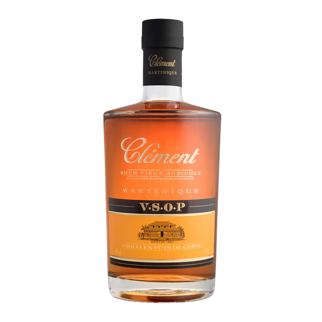 A bottle of Rhum Clément V.S.O.P. by Rhum Clément showcases amber rum in clear glass with a black cap, gold and white label—a prime example of Martinique rum expertise.