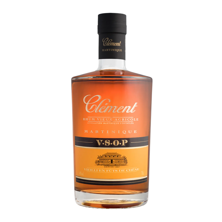 A bottle of Rhum Clément V.S.O.P. by Rhum Clément showcases amber rum in clear glass with a black cap, gold and white label—a prime example of Martinique rum expertise.