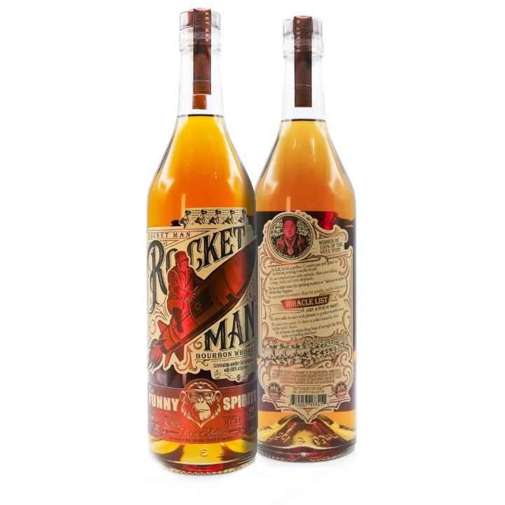 Two bottles of Rocket Man Bourbon Whiskey by Rocket Man are shown—one highlights the vintage-style rocket label, while the other displays the detailed back label. Both limited-edition bottles showcase the golden whiskey inside.