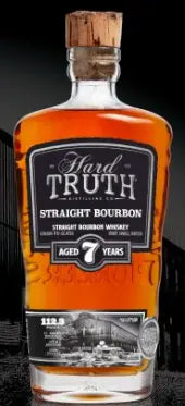 Hard Truth 7 Year Straight Bourbon Whiskey bottle, with a cork top and striking black, white, and orange label, stands out against a dark background—ideal for anyone seeking a premium Hard Truth bourbon experience.