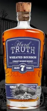 A bottle of Hard Truth 7 Year Wheated Bourbon Whiskey, aged 7 years, features a cork stopper and blue label displaying the Hard Truth brand name and whiskey details.