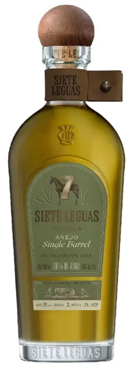A bottle of Siete Leguas Añejo Hungarian Oak Single Barrel Tequila 750mL, crafted by Siete Leguas with a wooden cap, green and gold label, and a tan leather strap around the neck, showcases the craftsmanship behind this exceptional Hungarian Oak Tequila.