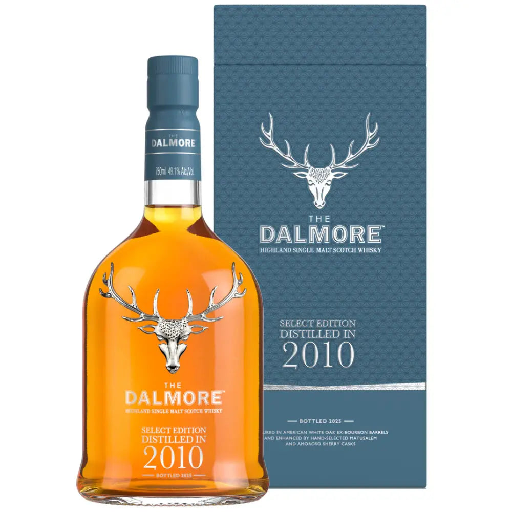 A bottle of The Dalmore Select Edition 2010 Highland Single Malt Scotch Whisky stands before its blue box, both adorned with a silver stag head logo and elegant white text, highlighting this refined release from The Dalmore.