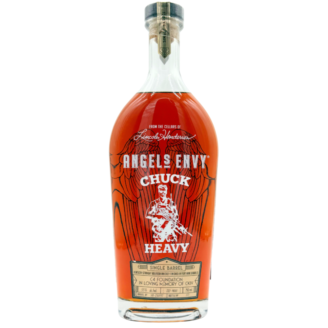 An Angel's Envy Chuck Heavy C4 Foundation bourbon bottle, featuring deep etching, gold and white text, a guitar illustration, and a front dedication. The amber whiskey shines through the bold design.