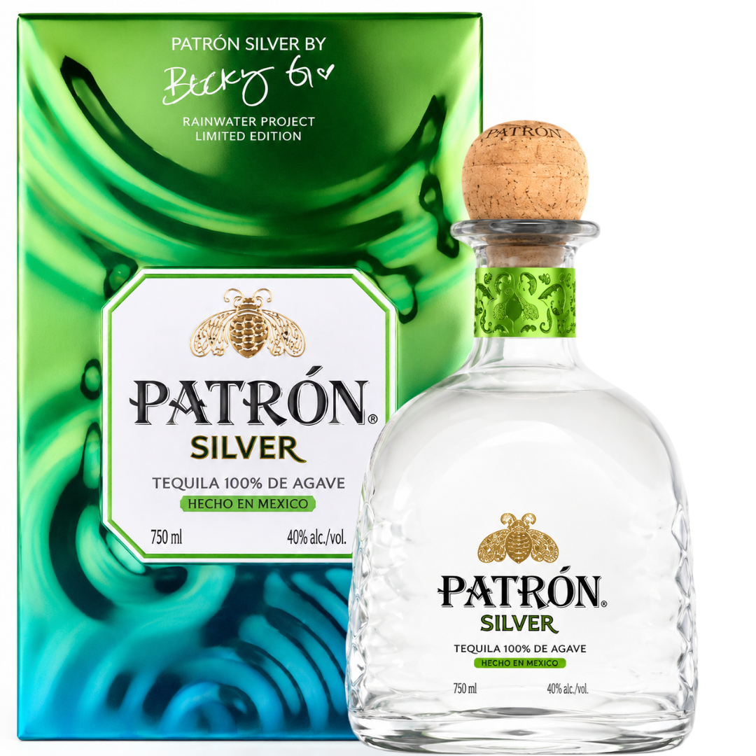 A 750mL bottle of Patrón Silver Isla Urbana x Becky G Limited Edition Tequila stands before a vibrant box with the Patron logo and Becky G's signature, commemorating their exclusive Rainwater Project collaboration.