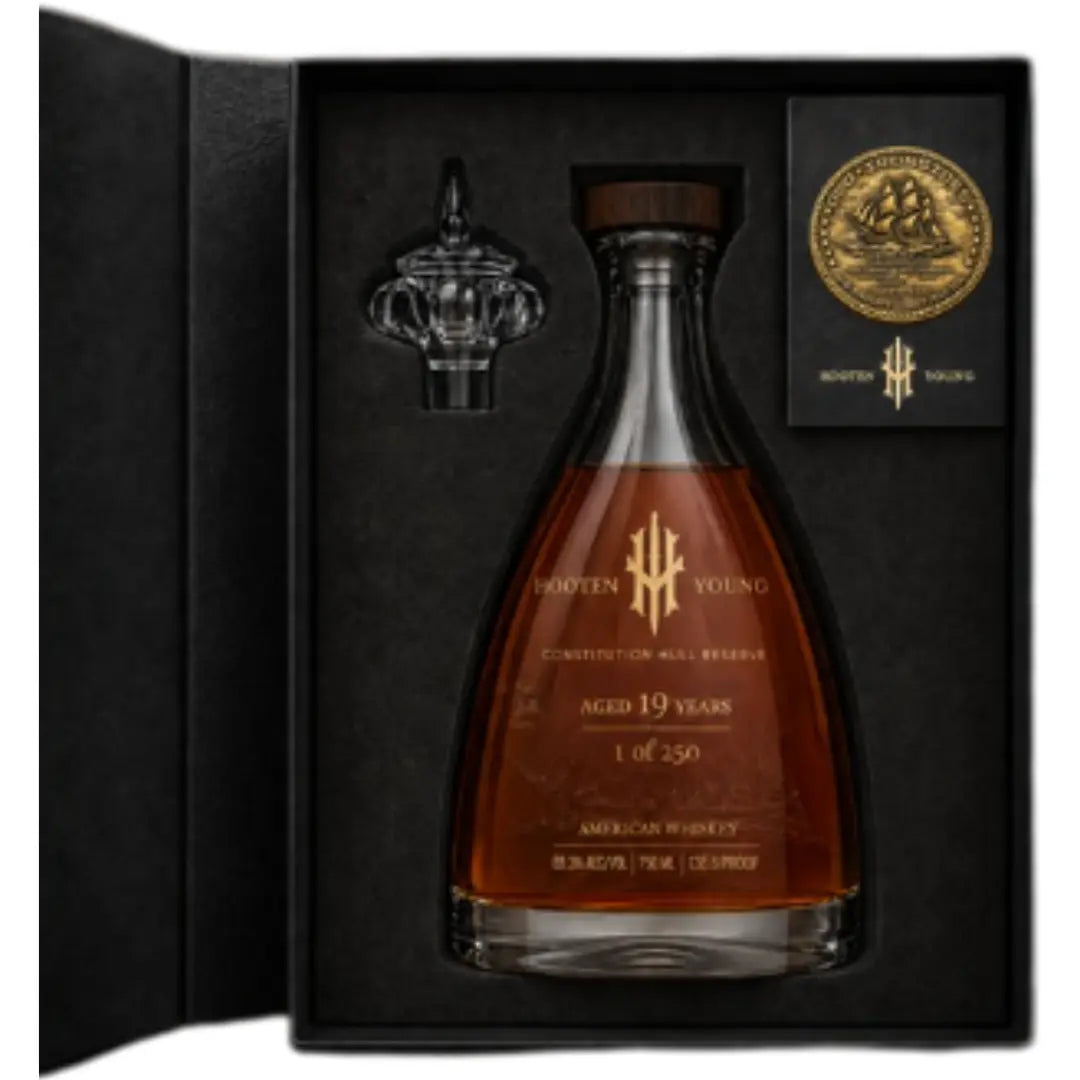 Experience the Hooten Young Constitution Hull Reserve 19 Year American Whiskey in a luxury boxed set featuring a glass stopper, gold medallion, and black velvet-lined case—the ultimate limited edition collector’s piece from Hooten Young.