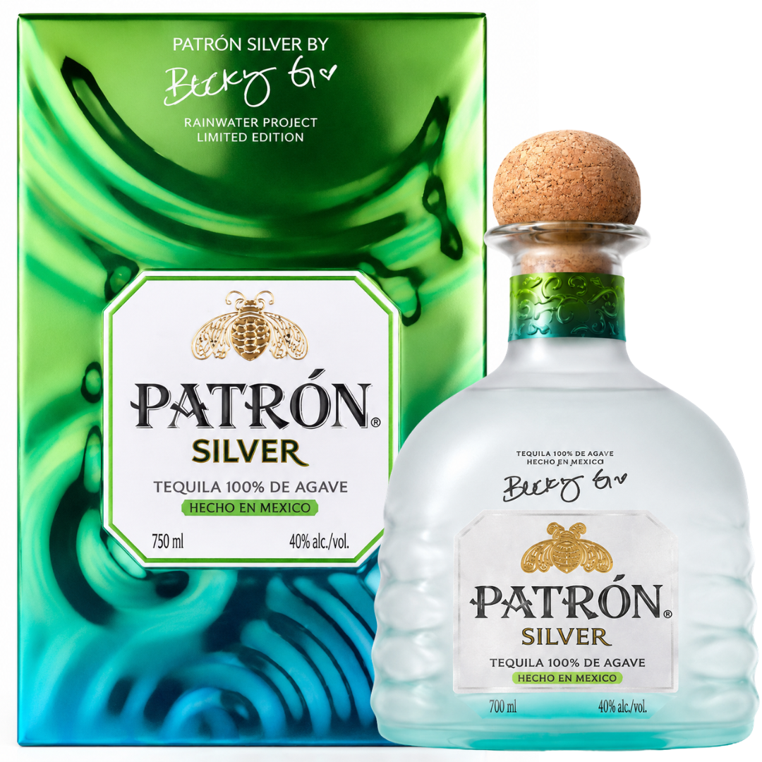 The Patrón Silver Isla Urbana x Becky G Frosted Bottle Limited Edition Tequila 700mL stands before a signed green and blue box, celebrating their exclusive collaboration for the Rainwater Project, and features 100% de Agave text.