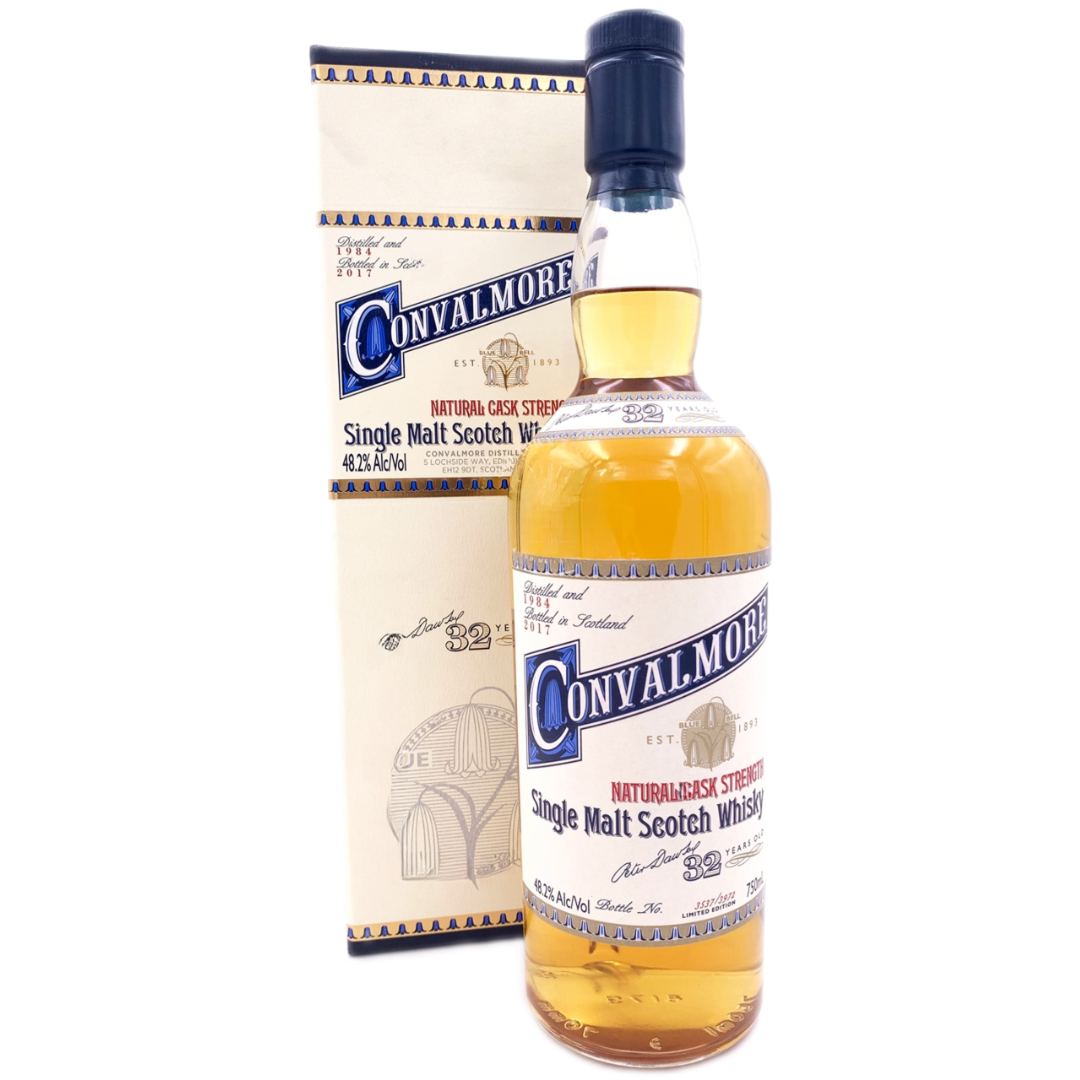 A bottle of Convalmore 32 Year Old Single Malt Scotch Whisky stands before its cream box, both showing blue and gold labels with intricate designs and text. The bottle is topped with a dark blue cap and features the Convalmore brand name.