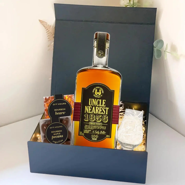 The Premium Bourbon Gift Box by Main Street Liquor features Uncle Nearest 1856 whiskey, Bourbon Bears, Bourbon Pecans, a clear glass, and decorative paper—a perfect whiskey gift set.
