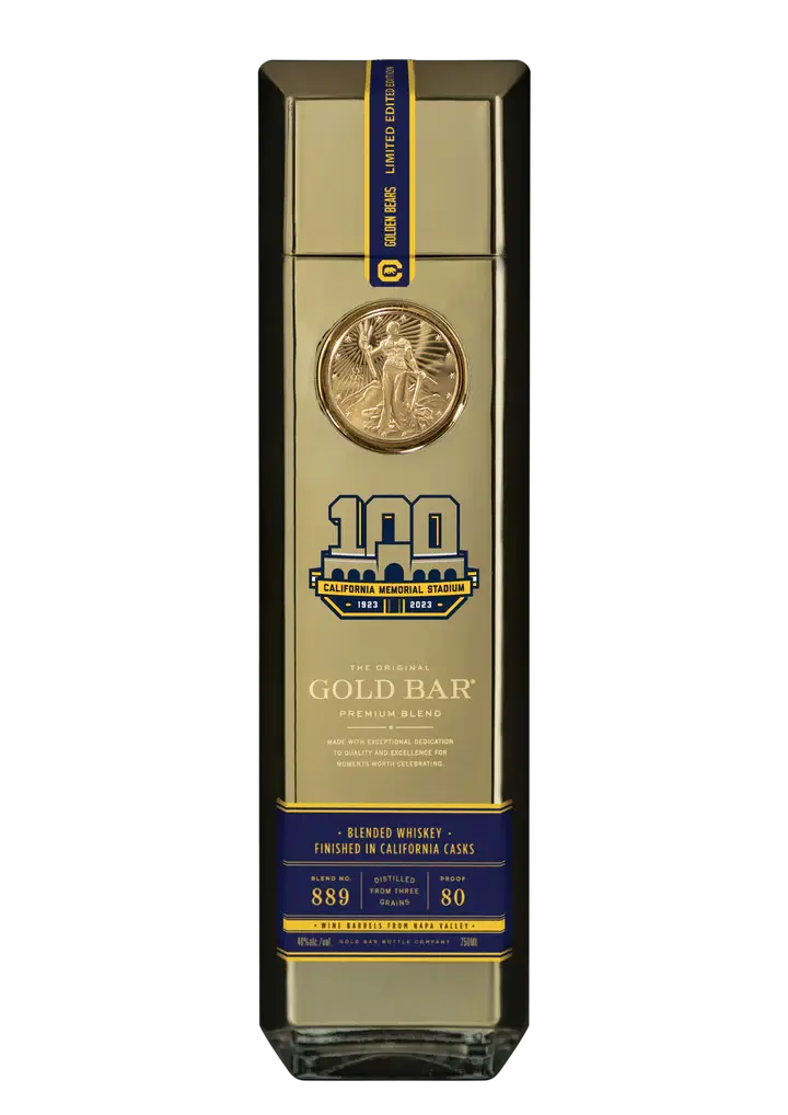 The Gold Bar California Memorial Stadium Limited Edition Blended Whiskey by Gold Bar features a tall, gold bar-shaped bottle with a medallion, 100 YEARS logo, and blue label—a collectible honoring the stadium’s centennial.
