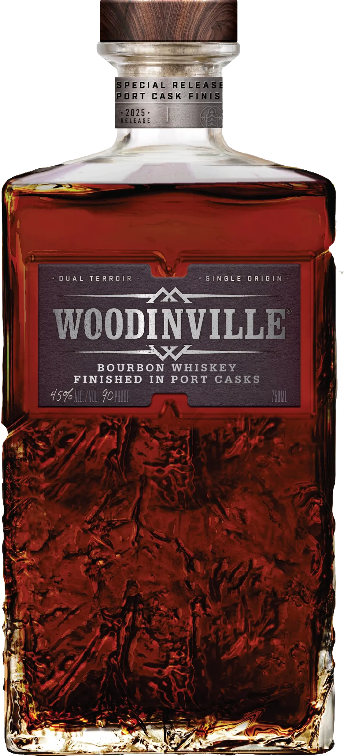 A bottle of Woodinville Port Finished Straight Bourbon, a straight bourbon whiskey from Woodinville, finished in ruby port casks. The label reads Special Release and indicates 45% ALC/VOL (90 PROOF), while the glass features a textured pattern on its lower portion.