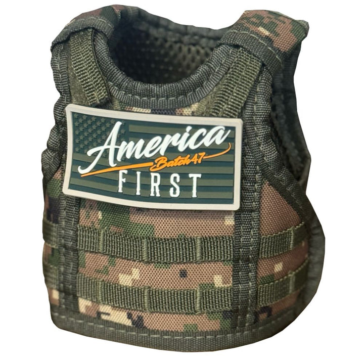 A camo-patterned vest featuring a patch that reads "America First" in white and orange over a stylized American flag, inspired by American craftsmanship and the America First Straight Bourbon Whiskey 2 Pack.