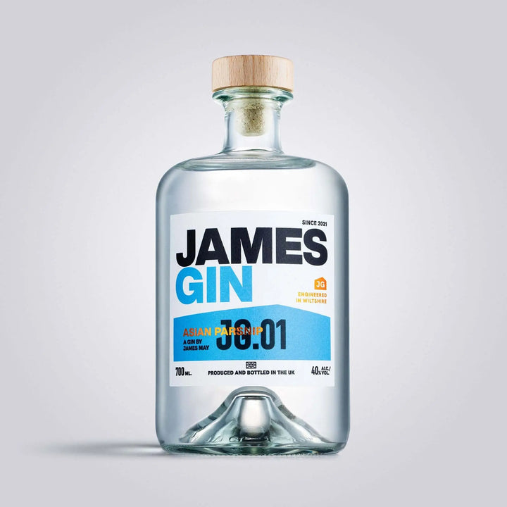 A clear glass 700mL bottle of James Gin Asian Parsnip (80 Proof) with a wooden cap and blue-and-white label is photographed on a light gray background, highlighting the premium British gin and its souvenir gift key chain.