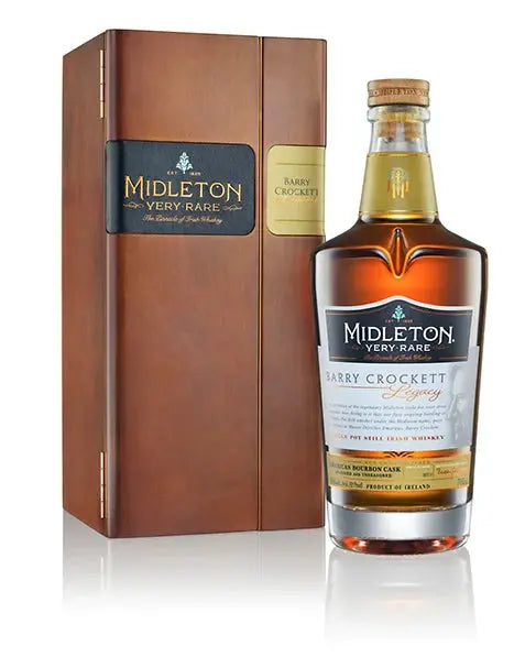 A bottle of Midleton Barry Crockett with a prominent label standing next to its open wooden presentation box.
