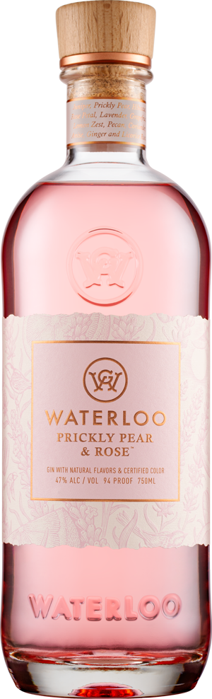 A clear glass bottle of Waterloo Prickly Pear & Rose Gin by Waterloo Gin features pale pink liquid, a wooden cap, and a light pink label with gold accents and text. WATERLOO is embossed on the bottom.