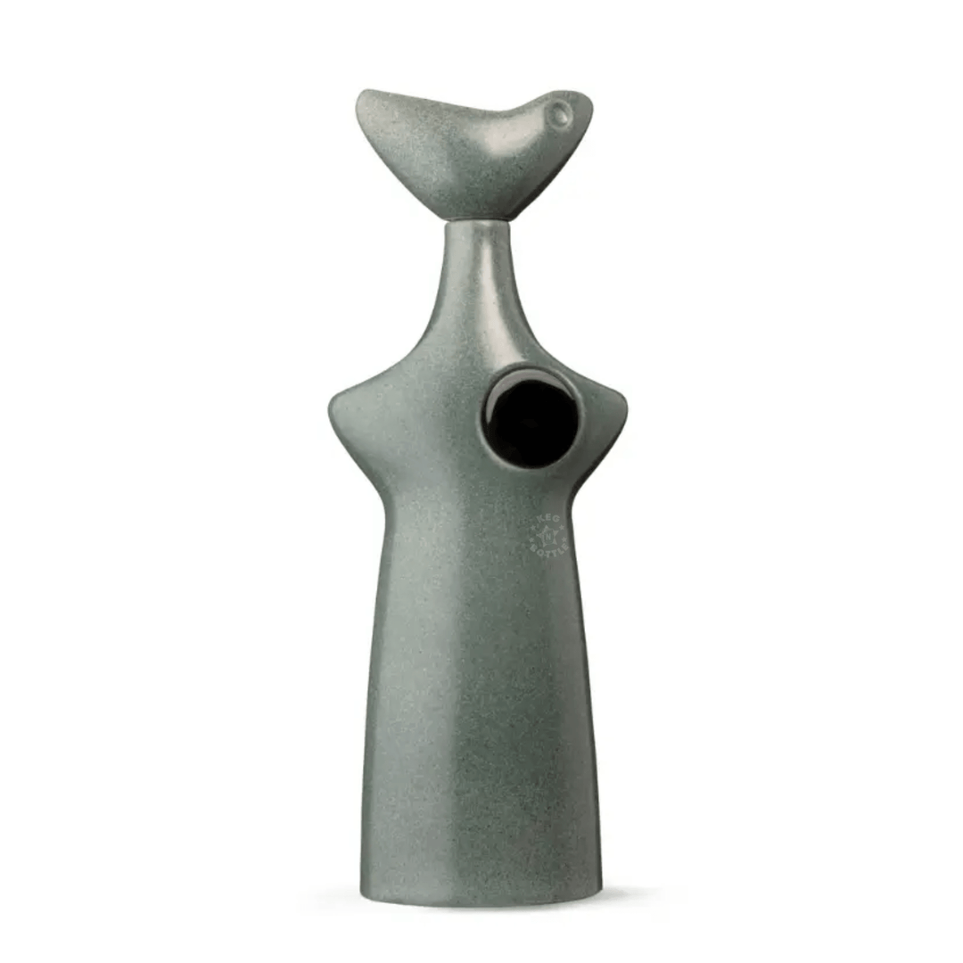Inspired by blue Weber agave, Casa Obsidiana Reposado Tequila (750 ml) features a smooth, abstract ceramic bottle in muted green with a stylized bird-head design, round black chest accent, gentle curves, and a minimalist matte finish.
