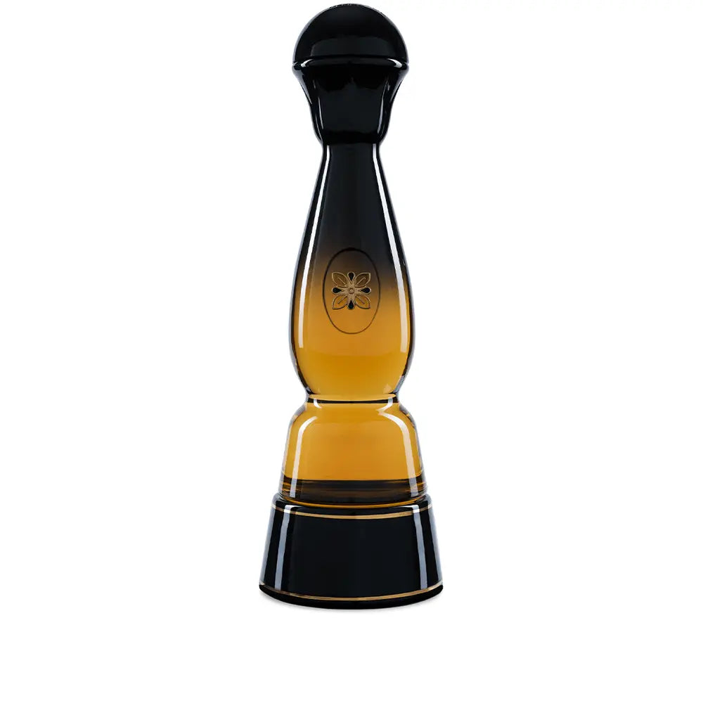A tall, elegant bottle with a black top and base, clear middle showing amber liquid, and a floral emblem—this is the limited edition Clase Azul Gold Tequila from Clase Azul Tequila.